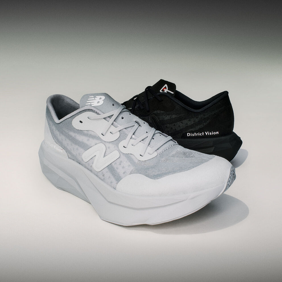 Single grey and single black District Vision & New Balance FuelCell SC Elite shoes sitting in grey studio environment with dark vignette