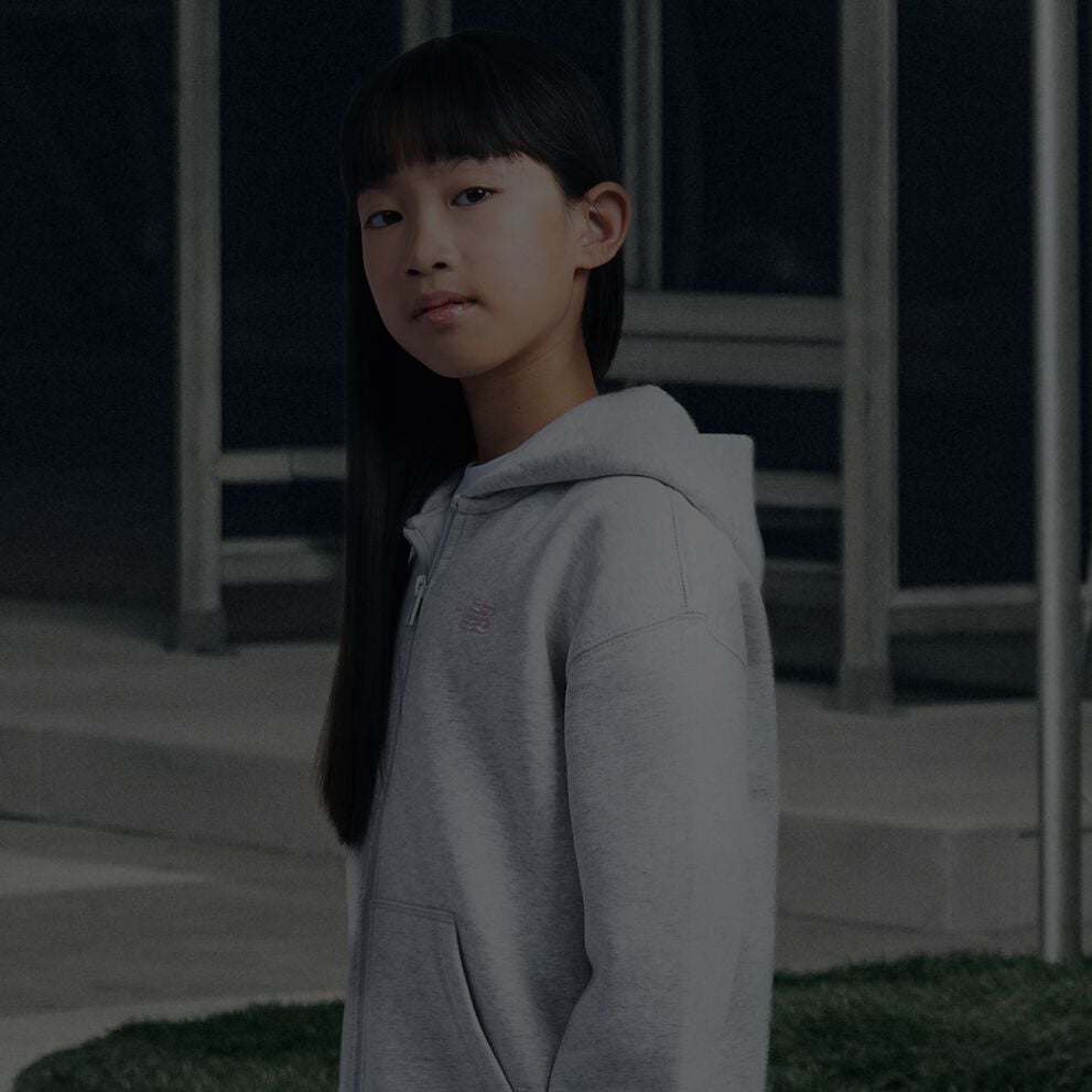 Girl wearing grey New Balance hoodie